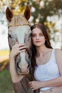 Portrait of Appaloosa cross horse with woman by Stacy van Zyl Photography