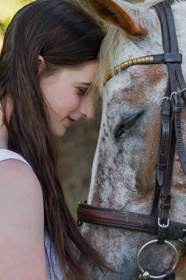 Woman and horse face to face
