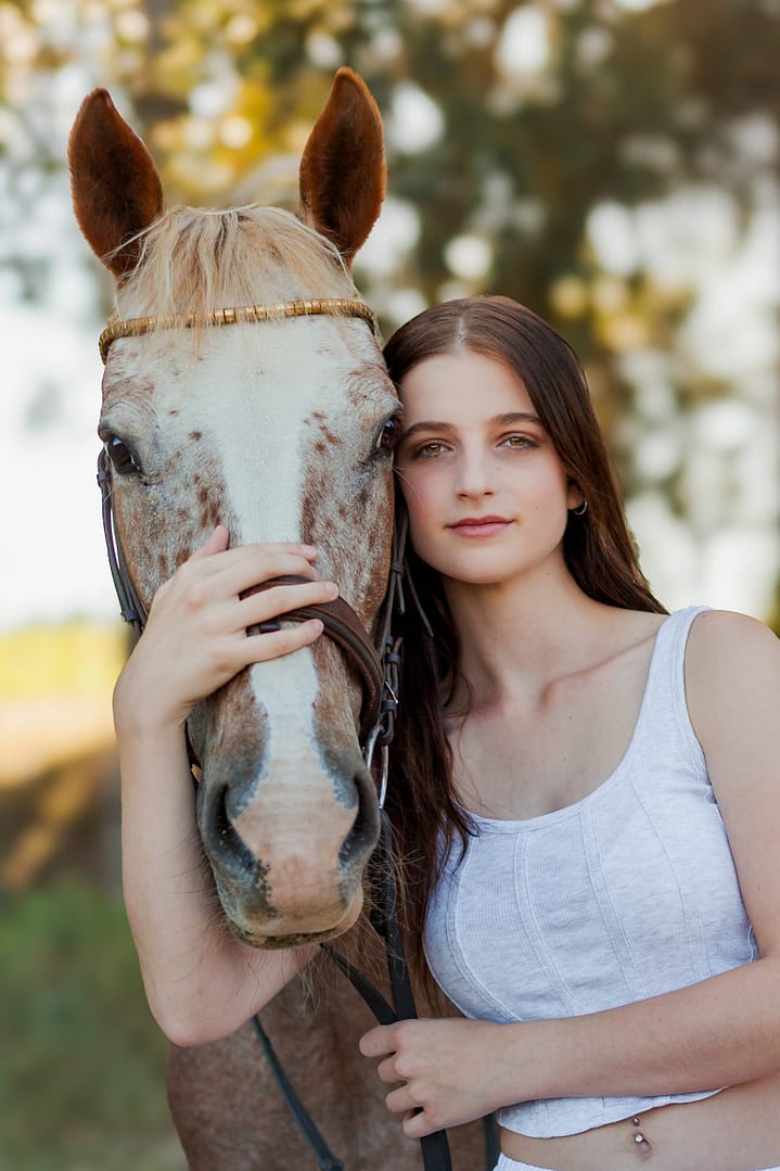 Portrait of Appaloosa cross horse with woman by Stacy van Zyl Photography