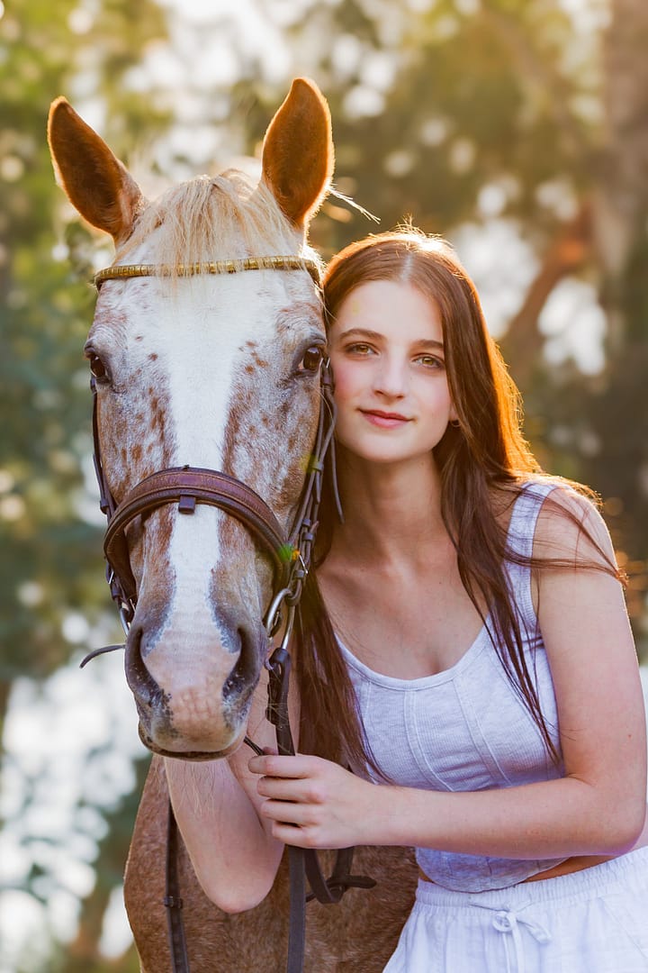 Woman and Appaloosa horse portrait.